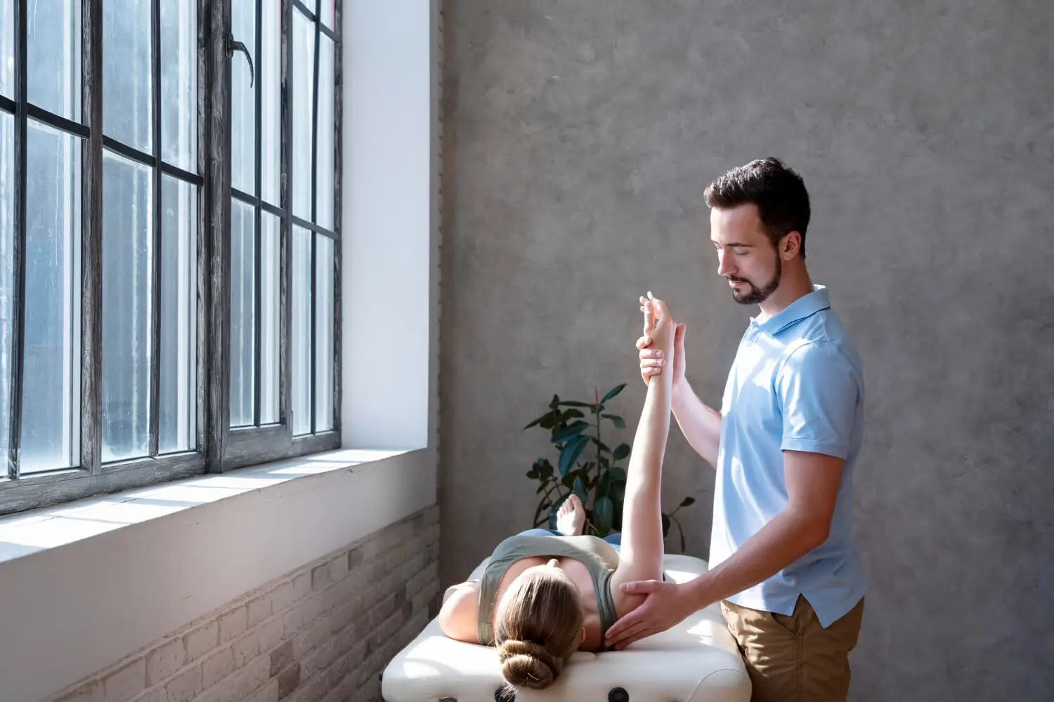 Male therapist performing somatic therapy on a female client to release past life and ancestral trauma stored in the body