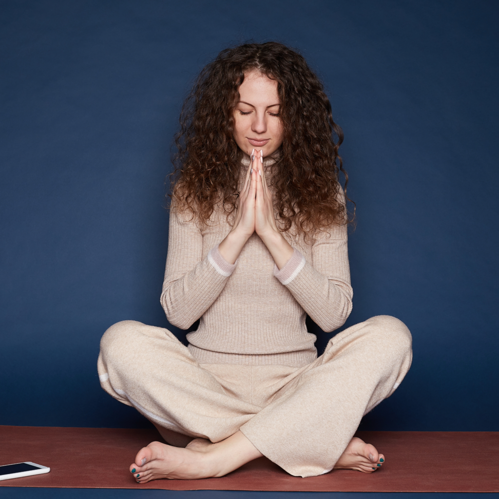 Woman meditating peacefully, embodying safety and relaxation through somatic therapy